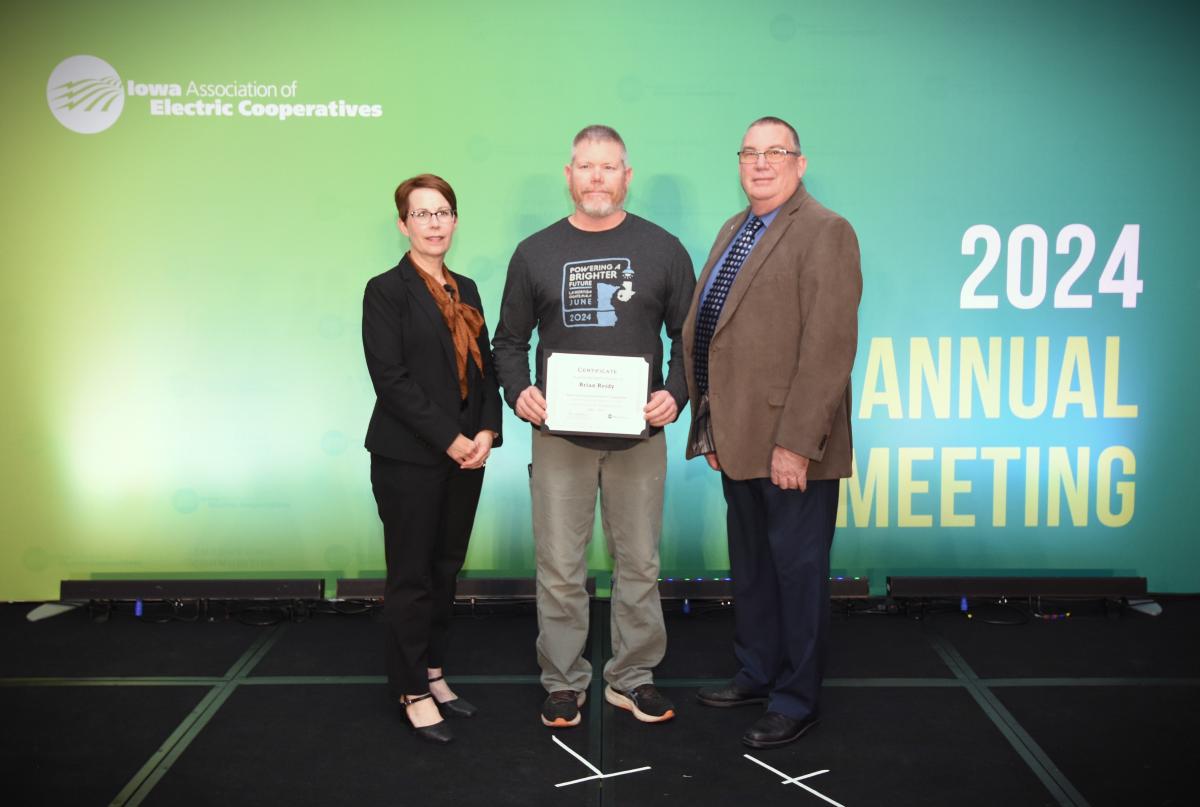 Brian Reidy being granted certificate by Kenny VandenBerg and Leslie Kaufman