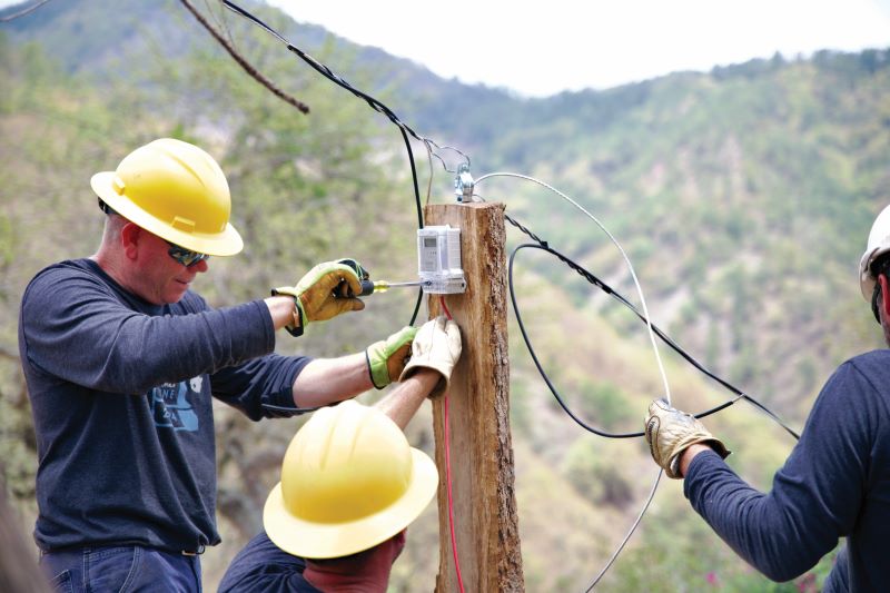 Closeup of Brian Reidy working on wiring