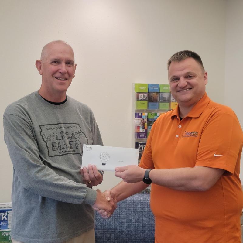 Randy Scheel receiving check from Nathan Groom